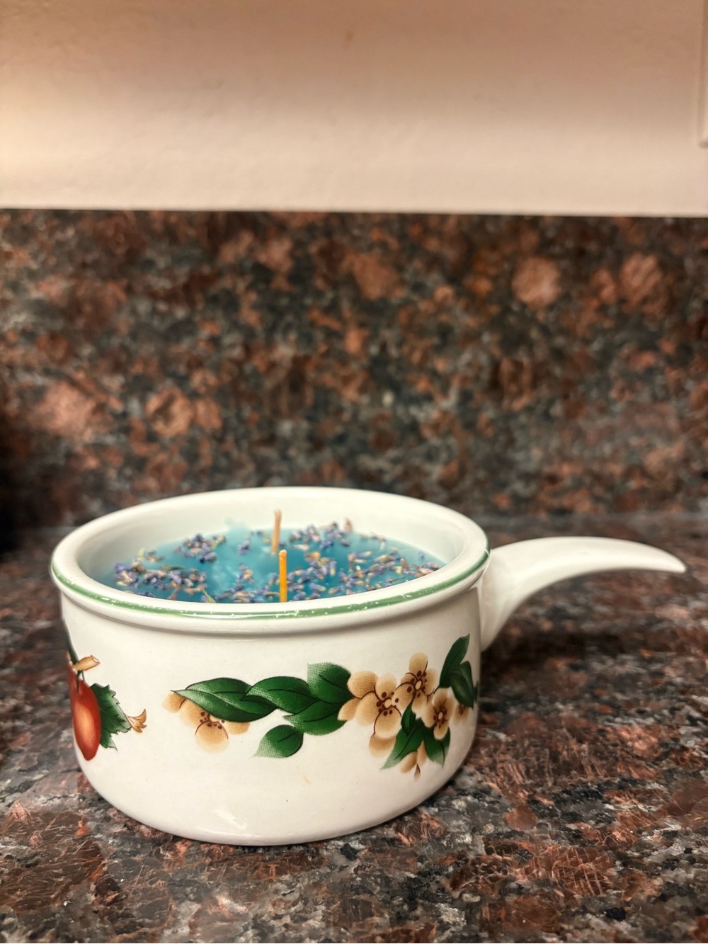 Handmade candle bubblegum scented with lavender in a floral kitchen piece